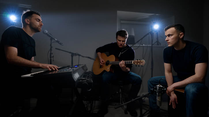 Gandekko band members playing acoustic instruments in bedroom music room